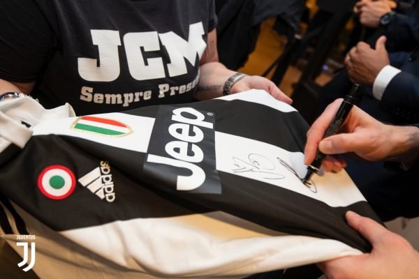 Juventus Player signing a jersey during one of the fan clubs' meet and greet.